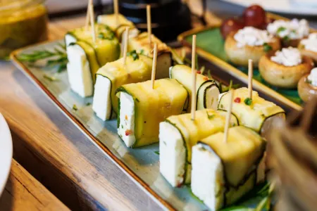 Zucchiniröllchen mit Feta und gefüllte Champignons auf dem Festbuffet